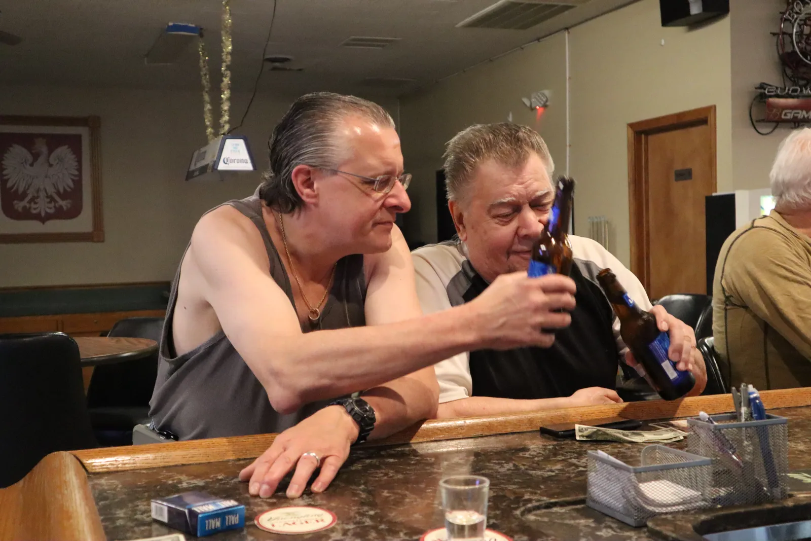 Members sharing a laugh over drinks at the club bar